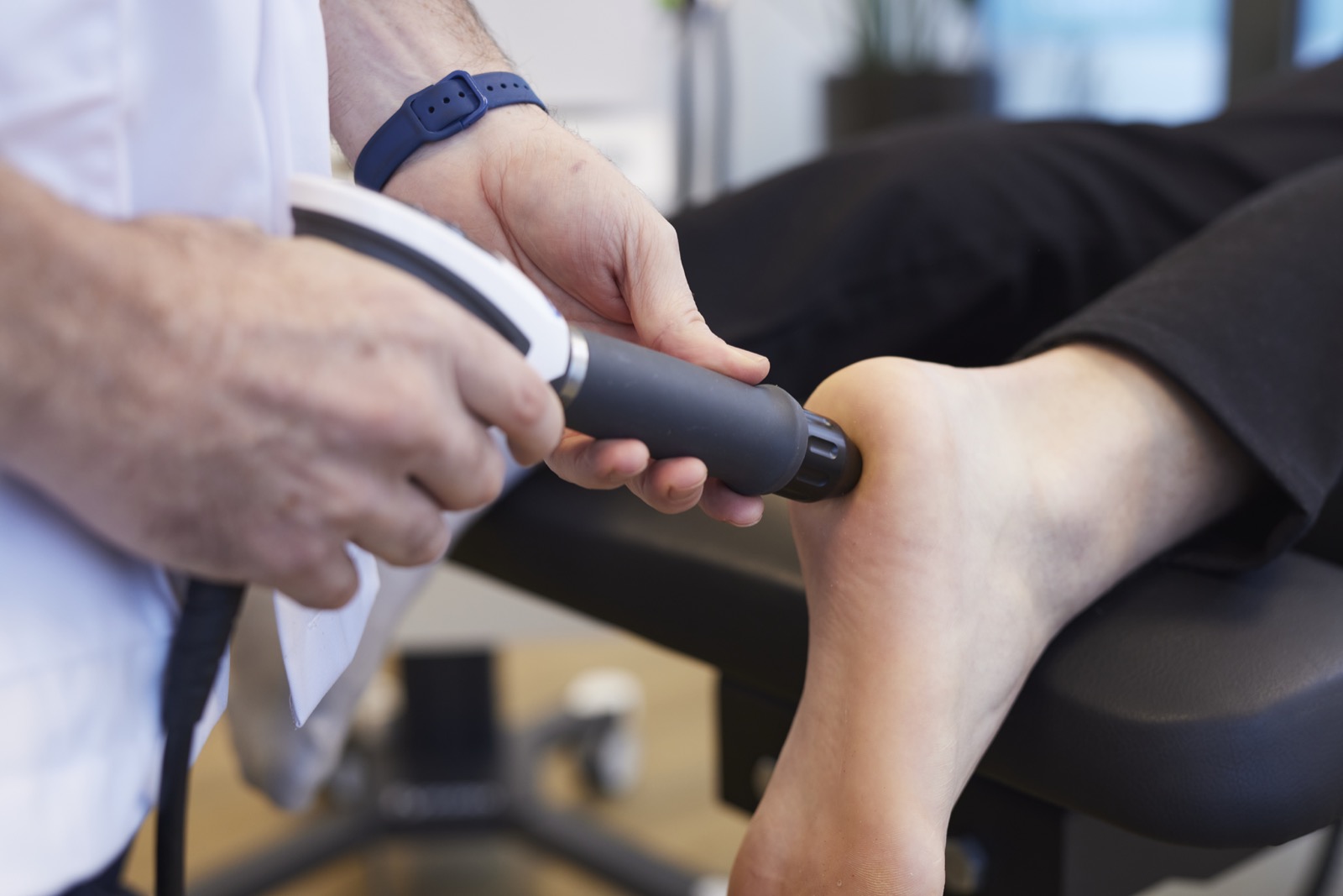 Shockwave handpiece at a knee during a practice shot